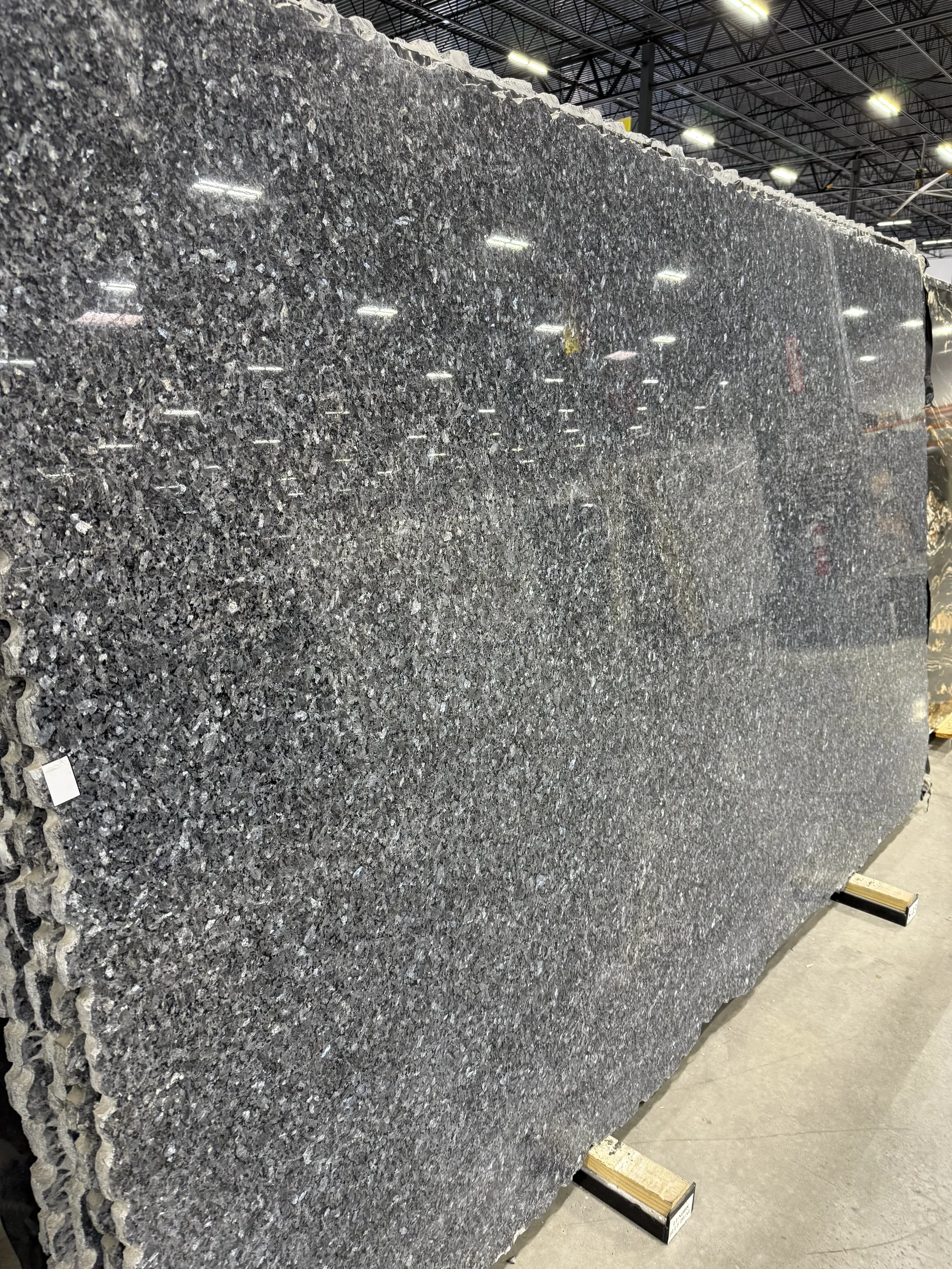 Whole granite slab in the slab yard: dark gray granite with silver flecks, selected by Dallas Countertop for a client