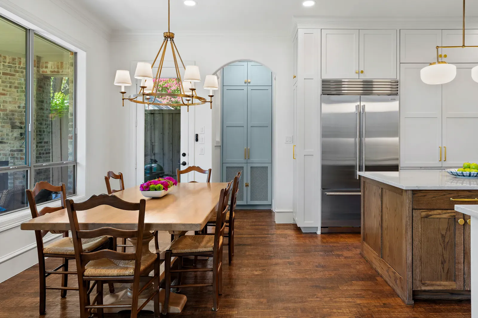 Stone counters on white cabinetry with a stained oak island in Lakewood, Dallas