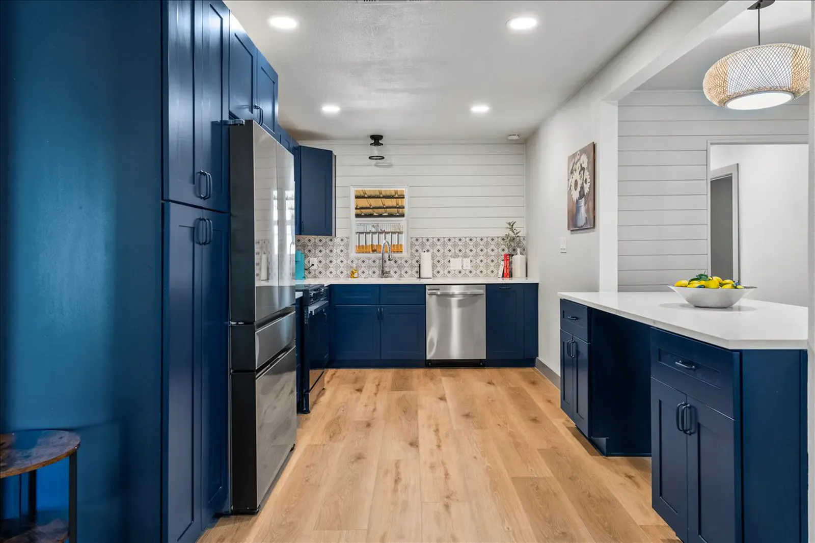 Bianco quartz counters on navy cabinets with a patterned tile backsplash in McKinney, TX