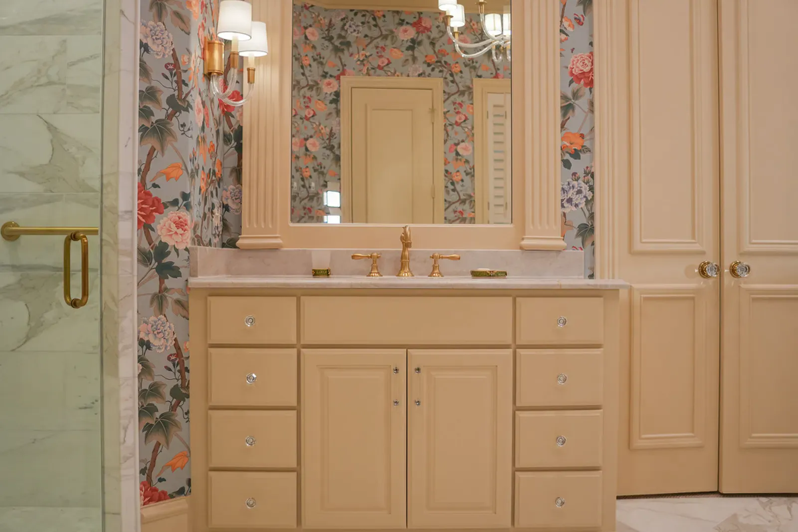 Stone vanity counters with brass hardware in a Dallas, TX bathroom